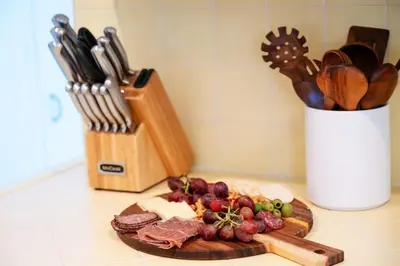a plate of food on a cutting board with knives at La Jolla Oasis - Spa, Sauna, Beach, Shops, UCSD in San Diego