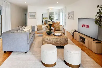 a living room with a couch and a tv at La Jolla Oasis - Spa, Sauna, Beach, Shops, UCSD in San Diego