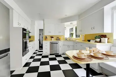 a kitchen with a black and white checkered floor at La Jolla Oasis - Spa, Sauna, Beach, Shops, UCSD in San Diego