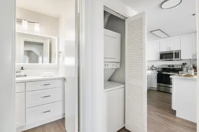 a white kitchen with white cabinets and a sink at Modern 1BD in La Jolla Mountain City Views Free Parking in San Diego