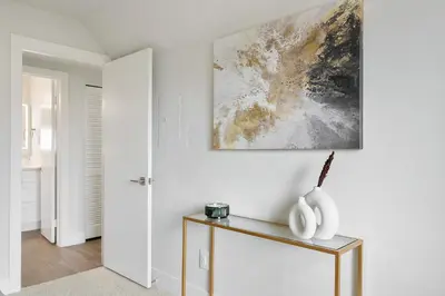 a living room with a table and a painting on the wall at Modern 1BD in La Jolla Mountain City Views Free Parking in San Diego