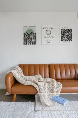 a brown leather couch in a living room with a blanket at Modern 1BD in La Jolla Mountain City Views Free Parking in San Diego