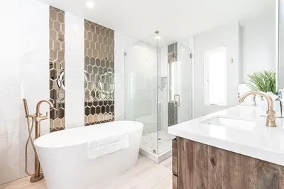 a bathroom with a tub and a sink and a shower at 8Br Retreat With Ac, Modern Upgrades, And Two Rooftop Decks By Beachview Rentals in Newport Beach