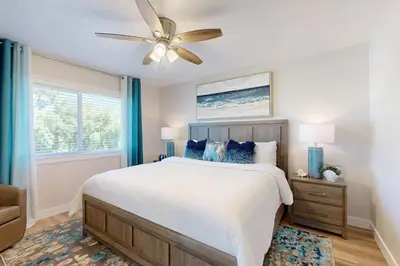 a bedroom with a bed and a ceiling fan at Carlsbad Coastal Retreat in Carlsbad