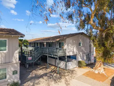 a house with a porch and a tree at Carlsbad Coastal Retreat in Carlsbad