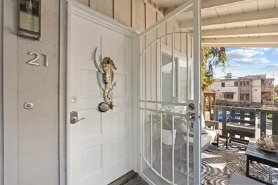 a white door with a fish on it on a balcony at Carlsbad Coastal Retreat in Carlsbad