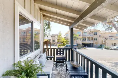 a screened porch with a bench and a view of a street at Carlsbad Coastal Retreat in Carlsbad