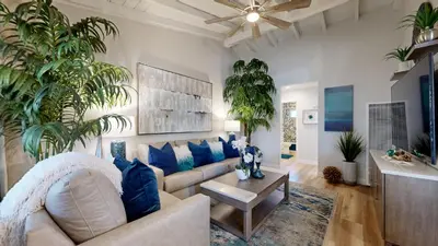 a living room with a couch and blue pillows at Carlsbad Coastal Retreat in Carlsbad
