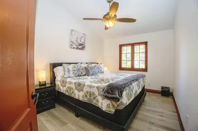 a bedroom with a bed and a ceiling fan at Oceanside Tropical Resort with HEATED POOL & SPA! in Oceanside