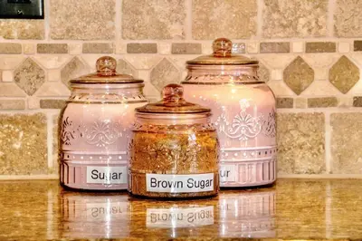 three jars of brown spices sitting on a counter at Oceanside Tropical Resort with HEATED POOL & SPA! in Oceanside