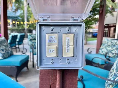 a metal box on a pole with chairs and tables at Oceanside Tropical Resort with HEATED POOL & SPA! in Oceanside