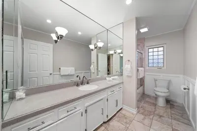 a bathroom with a sink and a toilet and a mirror at Stunning View Estate with Pool & Game Room in La Mesa