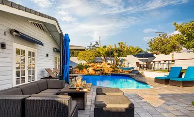 a patio with a pool and chairs and a table at Stunning View Estate with Pool & Game Room in La Mesa