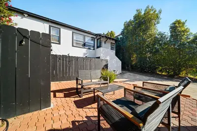 a patio with two benches and a fence at Little Italy Home with Parking and Backyard in San Diego