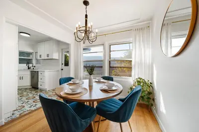 a dining room with a table and blue chairs at Little Italy Home with Parking and Backyard in San Diego