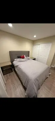 a bedroom with a large white bed with a red pillow at Nice home in Irvine