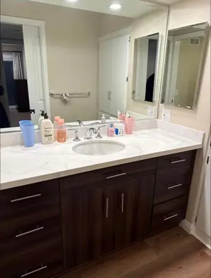 a bathroom with a sink and a large mirror at Nice home in Irvine