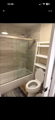 a bathroom with a toilet and a glass shower at Nice home in Irvine