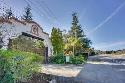 a building with an archway on the side of a road at Romantic Retreat at Rancho Las Lomas Pet Friendly