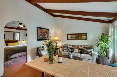 a living room with a table and a couch at Romantic Retreat at Rancho Las Lomas Pet Friendly