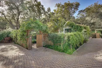 a garden with a wooden gate and a fence at Romantic Retreat at Rancho Las Lomas Pet Friendly