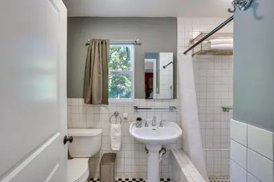 a white bathroom with a sink and a toilet at Spacious Courtyard and Spanish Charm Silverado Home
