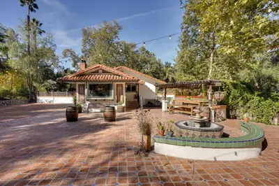 a brick patio with a fountain in front of a house at Spacious Courtyard and Spanish Charm Silverado Home