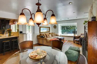 a kitchen and living room with a glass table at Spacious Courtyard and Spanish Charm Silverado Home