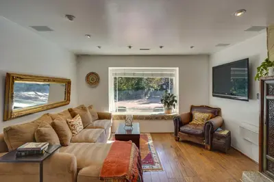 a living room with a couch and a chair at Spacious Courtyard and Spanish Charm Silverado Home