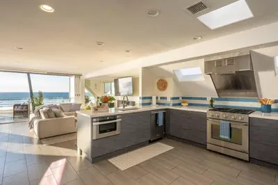 a kitchen and living room with a view of the ocean at Casa Azul at Mission Beach Oceanfront Getaway in San Diego