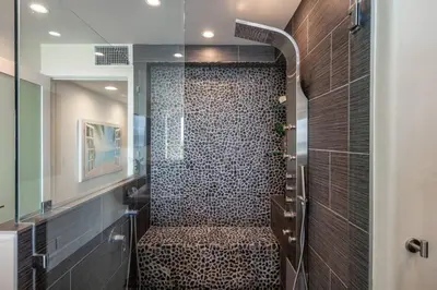 a bathroom with a shower with a bench in it at Casa Azul at Mission Beach Oceanfront Getaway in San Diego