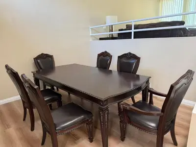 a dining room table with leather chairs and a table at \u53cc\u4eba\u95f4 in Irvine