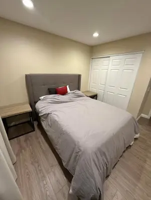 a bedroom with a bed with a red pillow on it at \u53cc\u4eba\u95f4 in Irvine