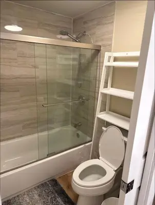 a bathroom with a toilet and a glass shower at \u53cc\u4eba\u95f4 in Irvine