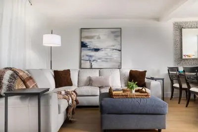 a living room with a white couch and a chair at Cozy Coastal Townhome in the Heart of Pacific Beach in San Diego