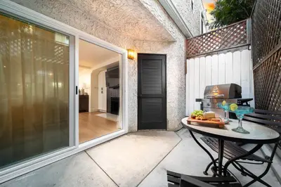 a patio with a table with a drink on it at Cozy Coastal Townhome in the Heart of Pacific Beach in San Diego