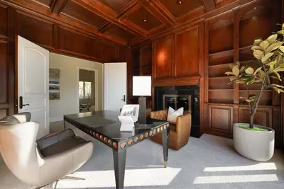 a living room with a table and chairs and a fireplace at ResortHome Pickle Ball Pool MovieRoom Gym Sauna Villa in Del Mar