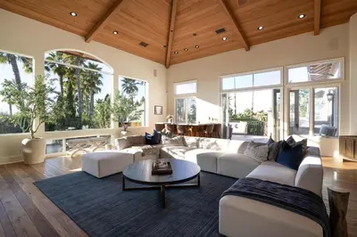 a living room with white furniture and large windows at ResortHome Pickle Ball Pool MovieRoom Gym Sauna Villa in Del Mar