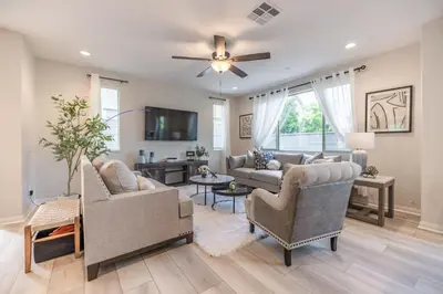 a living room with two couches and a ceiling fan at Marbella Lane - Elegant 5BR Home Rancho Mission in Ladera Ranch
