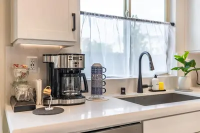 a kitchen counter with a coffee maker on a counter top at Marbella Lane - Elegant 5BR Home Rancho Mission in Ladera Ranch