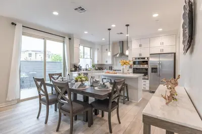 a kitchen and dining room with a table and chairs at Marbella Lane - Elegant 5BR Home Rancho Mission in Ladera Ranch