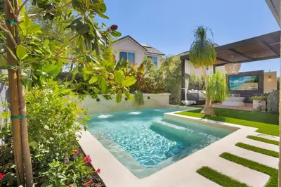 a swimming pool in the yard of a house at Marbella Lane - Stylish Dream Home in RMV w Pool in Mission Viejo