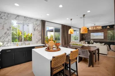 a kitchen and dining room with a table and chairs at Marbella Lane - Stylish Dream Home in RMV w Pool in Mission Viejo