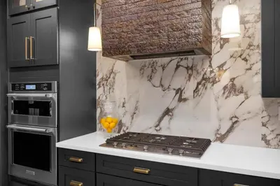 a kitchen with a counter with a stove top oven at Marbella Lane - Stylish Dream Home in RMV w Pool in Mission Viejo