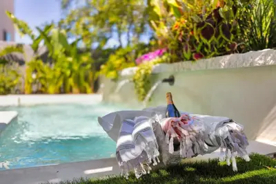 a bird statue sitting on the grass next to a swimming pool at Marbella Lane - Stylish Dream Home in RMV w Pool in Mission Viejo