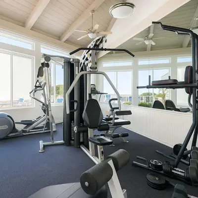 a gym with treadmills and weights in a room at Marbella Lane - Bayfront Bliss Sunset Views w Pool in San Diego