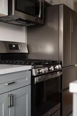 a kitchen with a black oven and a microwave at Walk to La Jolla Shores 2 homes Luxury Villa in San Diego