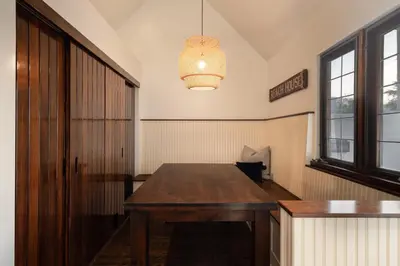an empty room with a wooden table and a light at Walk to La Jolla Shores 2 homes Luxury Villa in San Diego