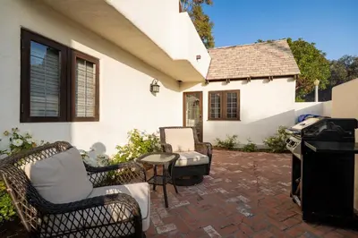 a patio with wicker chairs and a grill in front of a house at Walk to La Jolla Shores 2 homes Luxury Villa in San Diego