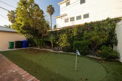 a golf course in a yard next to a house at Walk to La Jolla Shores 2 homes Luxury Villa in San Diego